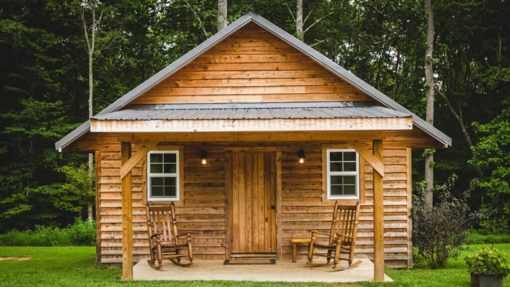 Wooden cabin with a lush forest in the background